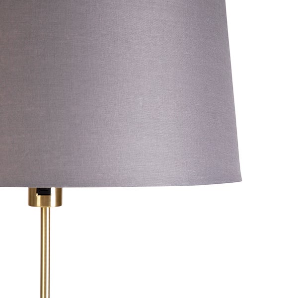 Grauer Lampenschirm auf goldfarbenem Lampenfuß