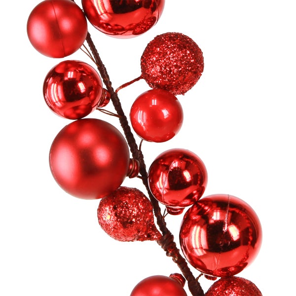 Dekozweig mit roten Weihnachtskugeln