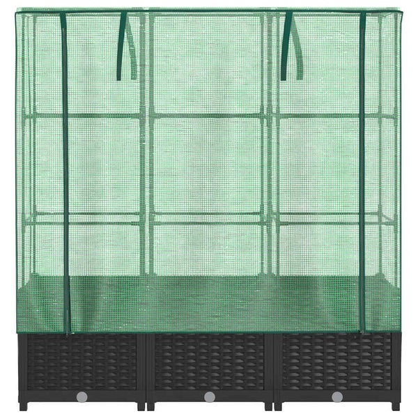 Gewächshaus mit grüner Gitterfolie und dunklem Pflanzkasten in Rattan-Optik.