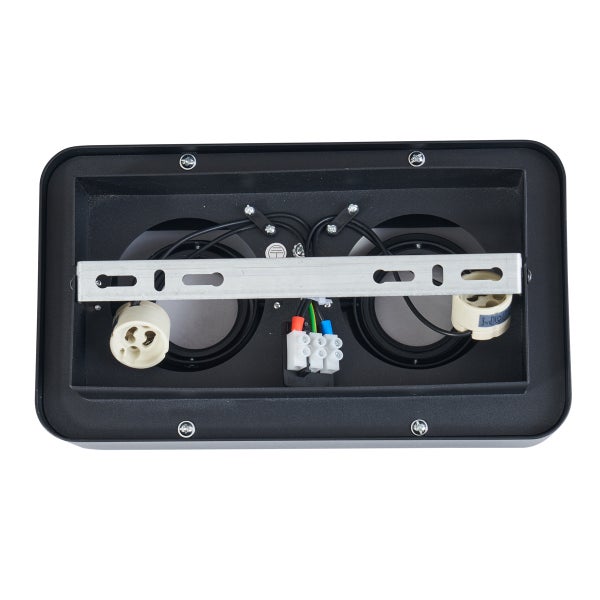 Innenansicht einer schwarzen Lampe mit Fassungen und Klemmen