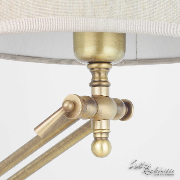 Detailaufnahme einer verstellbaren Messinglampe mit Stoffschirm