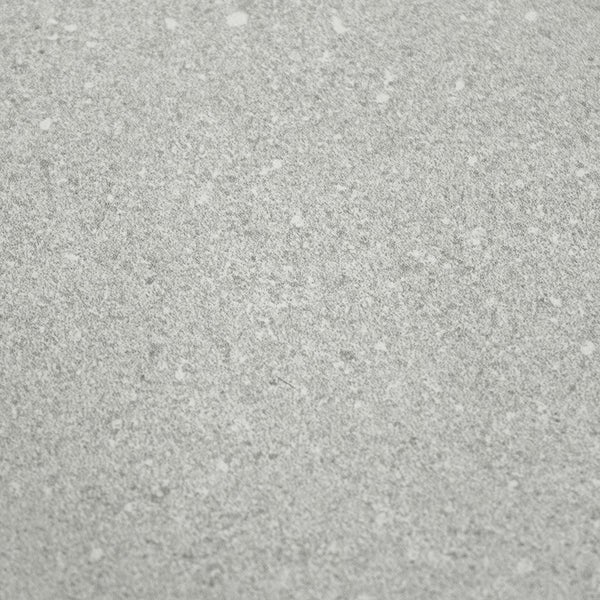 Detailansicht einer fein gesprenkelten Oberfläche einer Fliese oder Arbeitsplatte mit strukturierter Textur