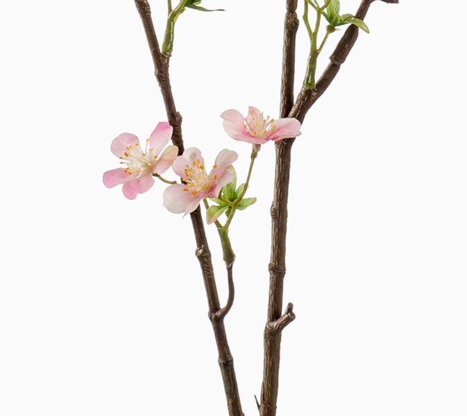 Künstlicher Dekozweig mit rosa Blüten und grünen Knospen an braunen Zweigen.