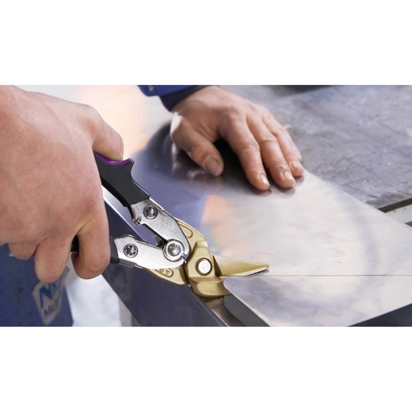 Blechschere beim Schneiden eines Metallblechs auf einer Werkbank.