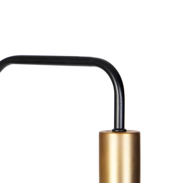Detail einer Stehlampe mit schwarzem Gestell und zylinderförmigem, goldenem Lampenfuß