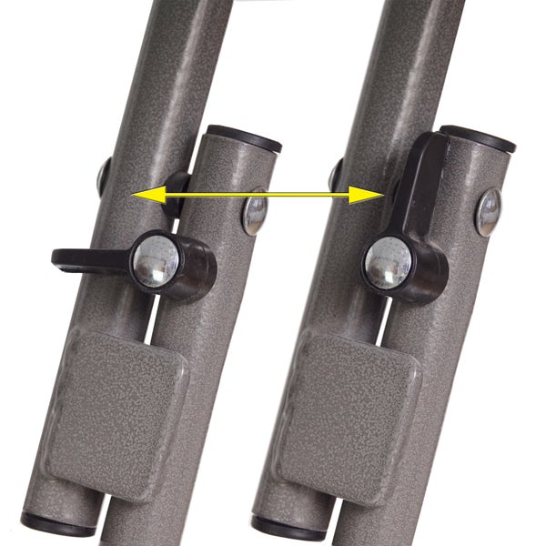 Detailansicht eines Feststellhebels an einem Metallrohrgestell mit gelbem Pfeil zur Veranschaulichung der Hebelbewegung.
