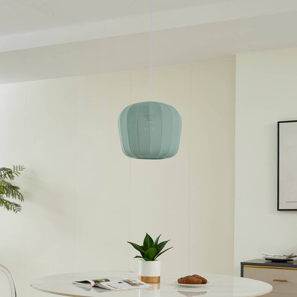 Moderne Pendelleuchte in Mintgrün über einem runden Esstisch in einem hellen, minimalistisch eingerichteten Raum.