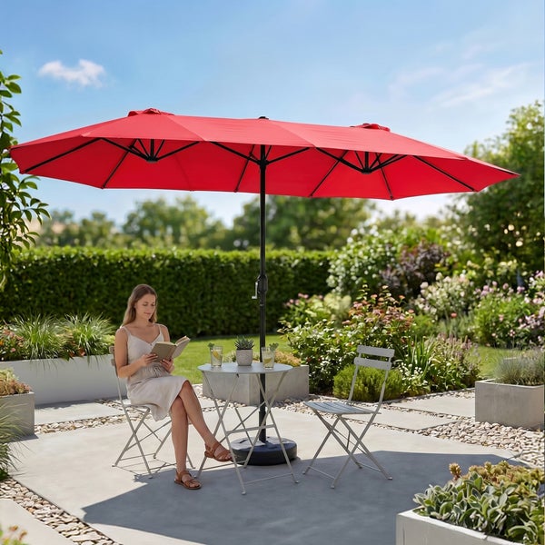 Großer roter Doppelsonnenschirm auf einer organisierten Gartenterrasse mit Metall-Bistromöbeln und modernen Pflanzgefäßen.