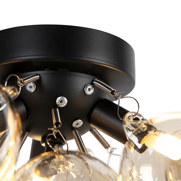 Detailaufnahme einer Deckenleuchte mit Glühbirnen und Federmechanismus