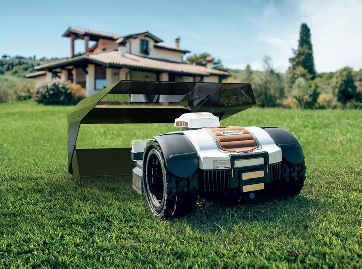 Mähroboter auf einer Rasenfläche vor einem Haus