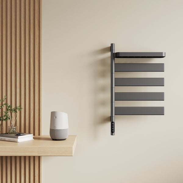Moderner elektrischer Handtuchheizkörper in Anthrazit mit horizontalen Lamellen und Digitalanzeige, an einer Wand neben einer Holzlamellenwand.