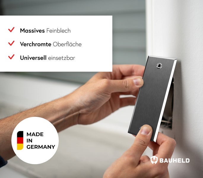 Ein Handwerker installiert eine Abdeckplatte aus Metall über einer Aussparung in der Wand. Made in Germany Siegel und Bauheld Logo sind sichtbar.