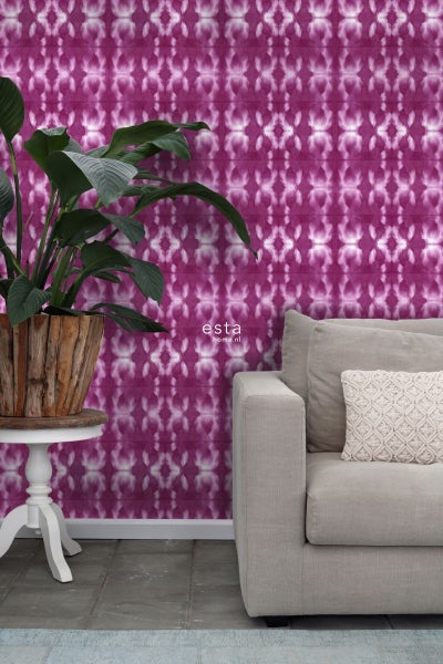 Wohnzimmer mit gemusterter Tapete, Pflanze im Holzkorb und Sofa