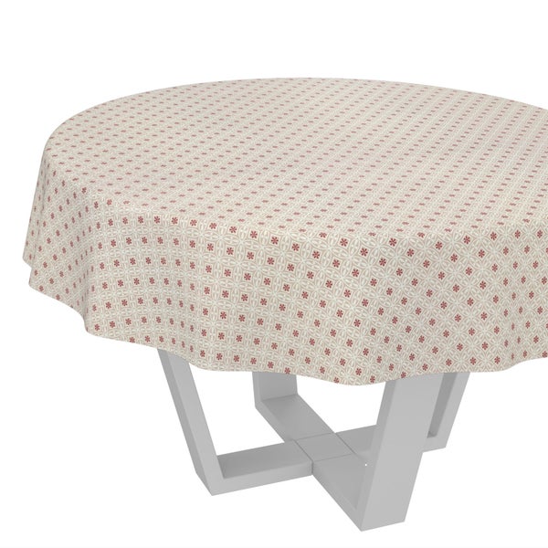 Runde Tischdecke mit floralem Muster auf einem runden Tisch mit modernem Gestell.