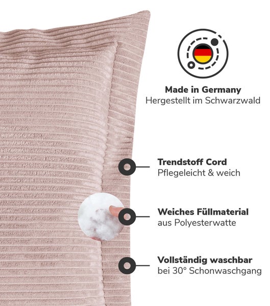 Zwei graue Kissen aus Cordstoff auf einem Sofa