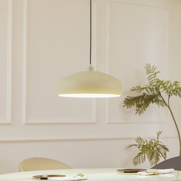 Moderne Pendelleuchte mit flachem Metallschirm über einem Esstisch in einem hellen Raum mit Wandleisten.
