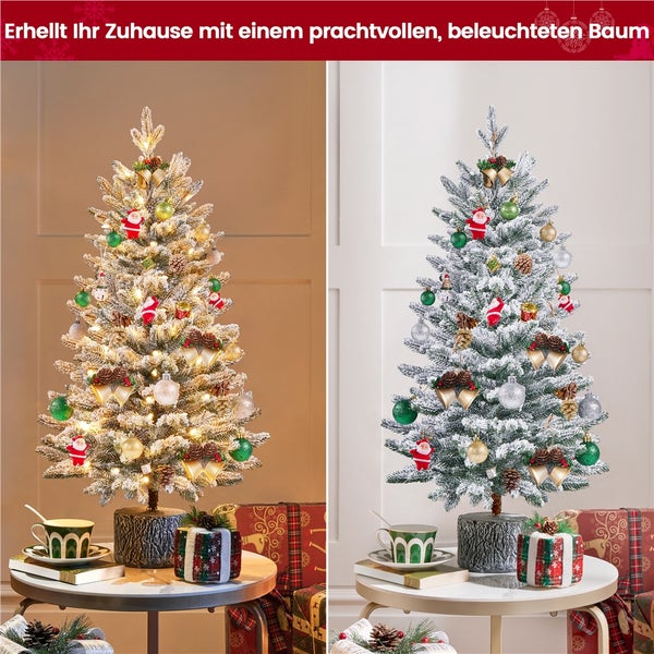 Beleuchteter künstlicher Weihnachtsbaum mit Dekoration auf einem Tisch