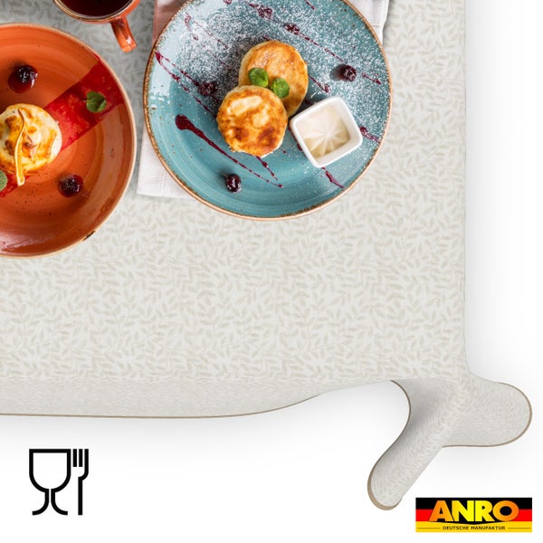 Abwaschbare Tischdecke mit Blattmuster, lebensmittelecht, abgebildet mit Tellern und Speisen. ANRO Logo.