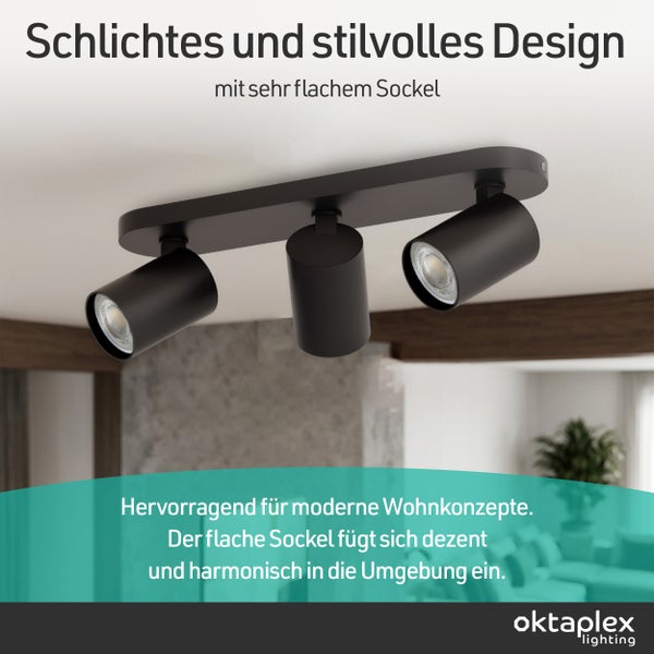 Moderne, dreiflammige Deckenleuchte in Schwarz mit flachem Sockel, montiert an einer hellen Decke in einem Wohnzimmer. oktaplex lighting Logo.