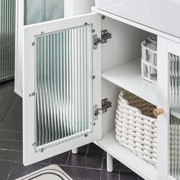 Detailaufnahme eines weißen Badezimmerschranks mit strukturierter Glastür und Ablagefächern