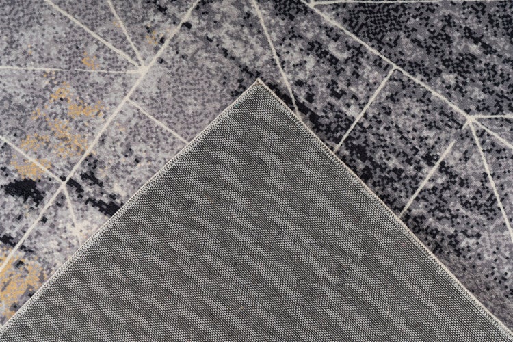 Teppich mit geometrischem Muster und detailreicher Rückseite aus Webstoff.