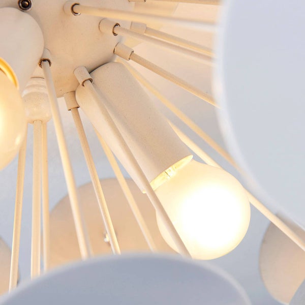 Detailansicht einer modernen Deckenleuchte aus Metall mit mehreren Armen und einem leuchtenden Leuchtmittel.