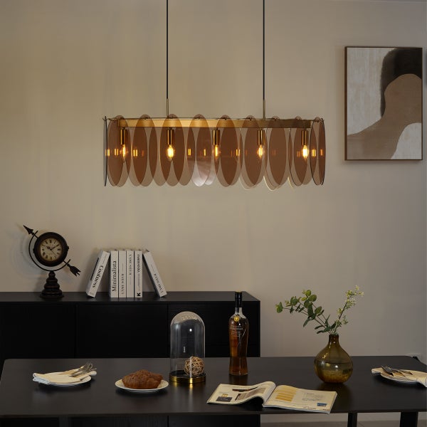 Esszimmer mit Pendelleuchte, Esstisch und Dekorationen auf einer Kommode