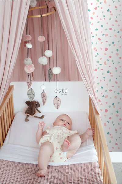 Baby im Kinderbett mit Mobile und Spielzeug