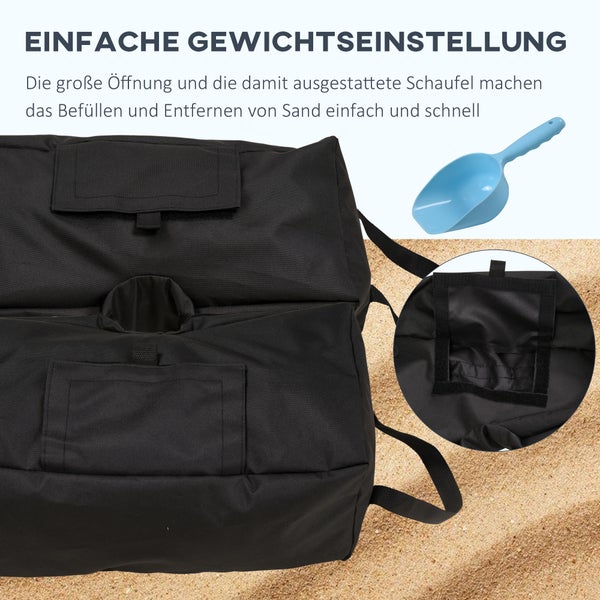 Schwarzer Textil-Gewichtssack mit einer großen Öffnung zum Befüllen und eine blaue Kunststoffschaufel auf Sand.