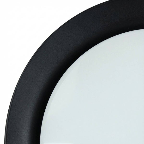 Detail einer runden Leuchte mit dunklem Rahmen