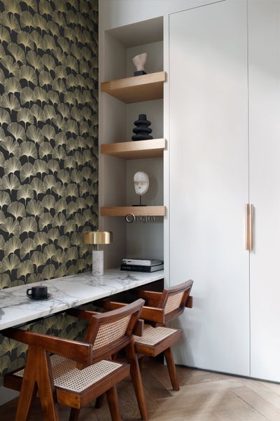 Elegantes Arbeitszimmer mit Tapete, Schreibtisch, Stühlen und Regalen