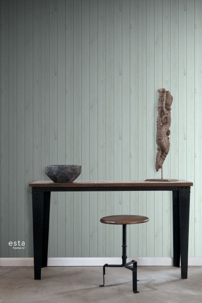 Raumansicht mit Holztapete, Tisch, Hocker und Dekorationen