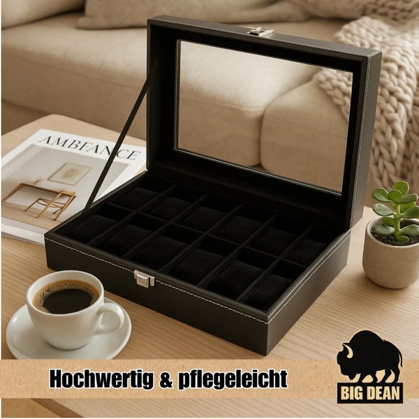 Uhrenbox aus schwarzem Kunstleder mit Glassichtfenster, gefüllt mit Armbanduhren und Schmuck auf einem Holztisch. Big Dean Logo.