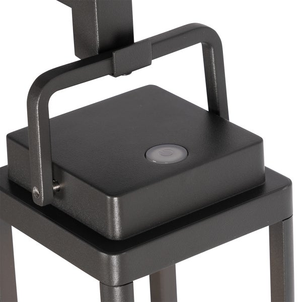 Detailansicht einer schwarzen Außenleuchte mit einem Ein- und Ausschalter auf der Oberseite und einem Metallbügel.