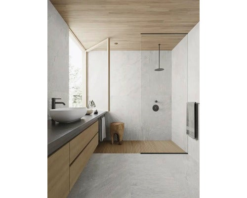 Heller Raum mit Fliesenboden, Esstisch und Zugang zum Garten durch Schiebetüren