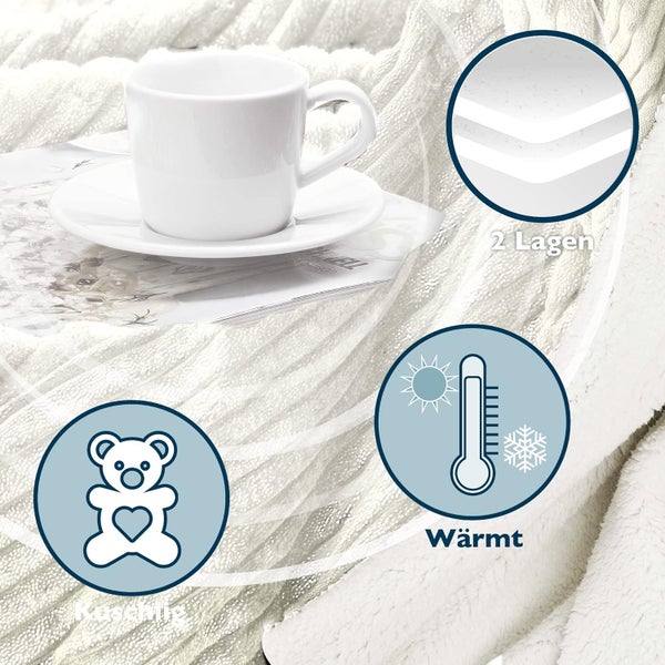 Weiche Kuscheldecke mit zwei Lagen Struktur, wärmend und flauschig, dekoriert mit Kaffeetasse auf einem Magazin.