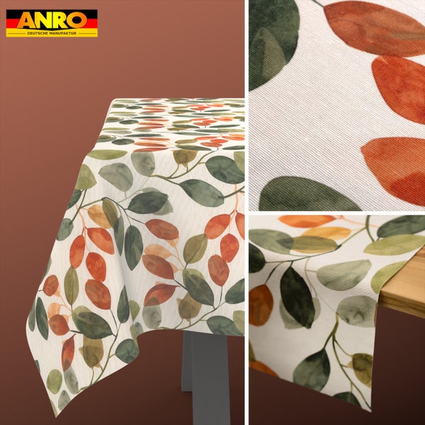ANRO Logo. Tischdecke mit grünem und orangefarbenem Blättermuster, Detailansicht der Gewebestruktur und Fall über eine Tischkante.