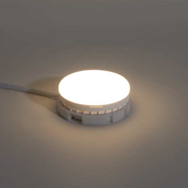 Runde, leuchtende LED-Möbeleinbauleuchte aus Kunststoff mit Kabelanschluss.