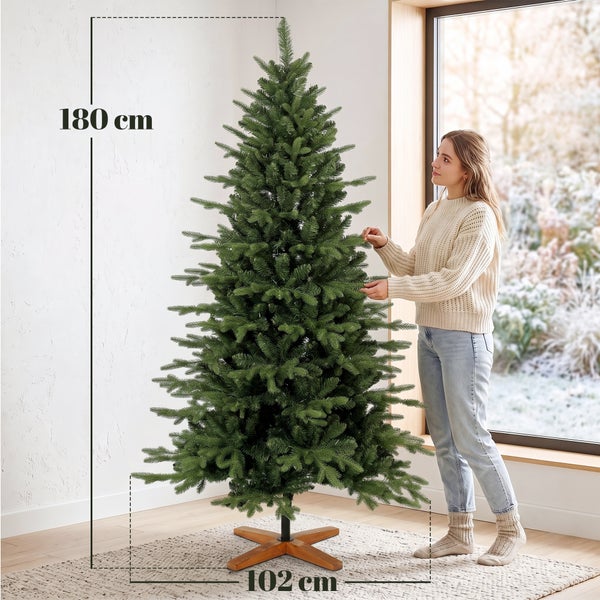 Künstlicher Weihnachtsbaum Vorher Nachher Vergleich mit Darstellung des Aufbiegens der Zweige bei einer Aufbaudauer von 25 bis 35 Minuten