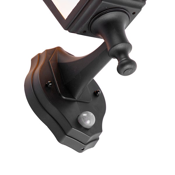 Nahaufnahme der Wandhalterung einer Außenwandleuchte mit integriertem Bewegungsmelder.