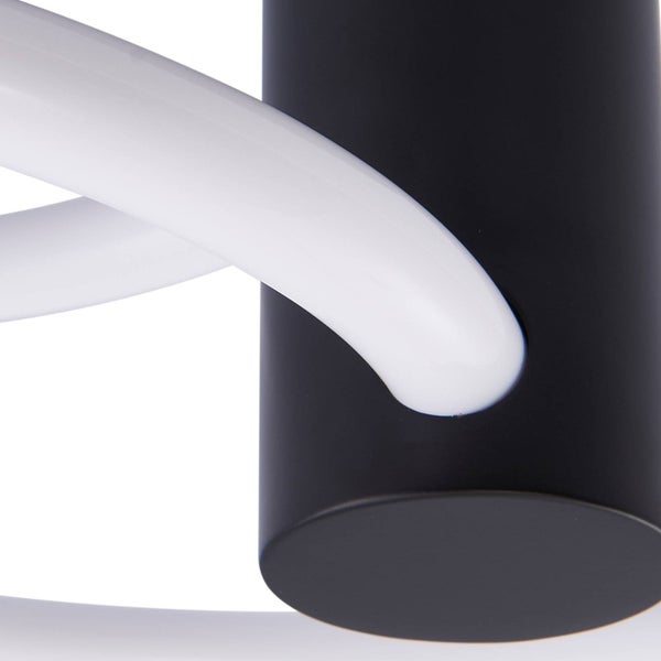 Moderne Leuchte, Detailansicht von schwarzem zylindrischem Sockel und geschwungenem weißem Lichtelement.