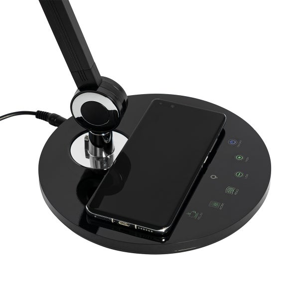 Schreibtischleuchte mit induktiver Ladestation und Mobiltelefon