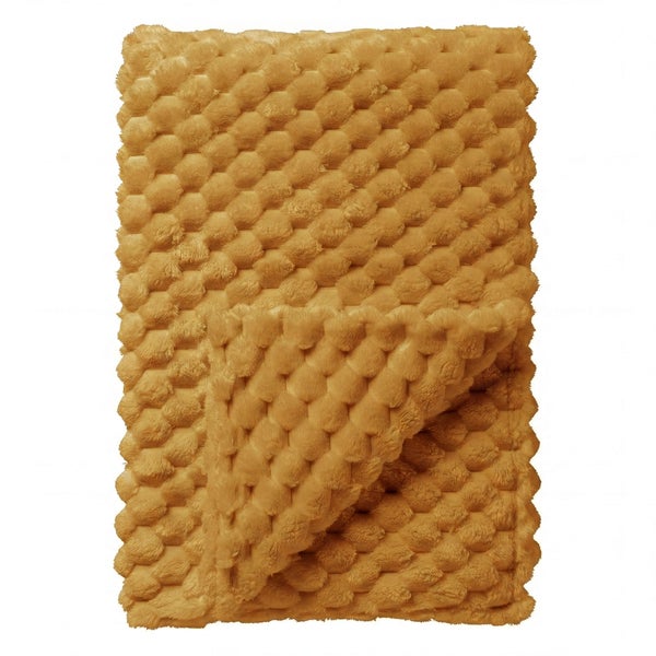 Weiche Wohndecke mit dreidimensionaler Noppenstruktur.