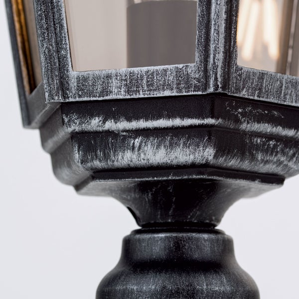 Detailansicht einer klassischen Außenlaterne aus Metall mit Glaseinsätzen und einer Oberfläche im Antik Look.