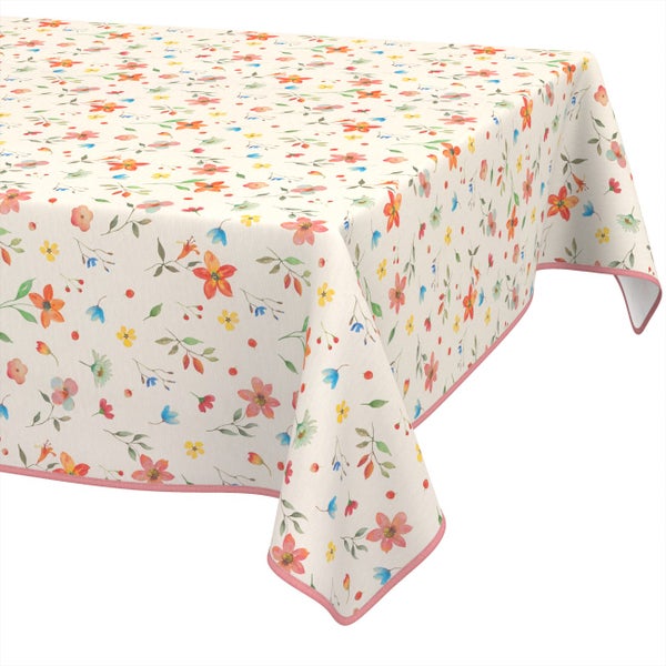 Tischdecke mit buntem Blumenmuster und rosa Saum.