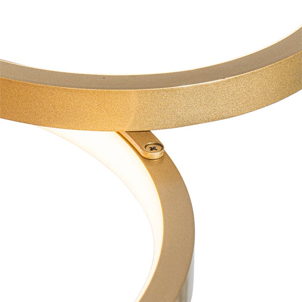 Detailaufnahme einer goldenen Ringlampe mit Schraubverbindung