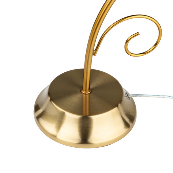 Detailansicht einer goldenen Leuchtenbasis mit Kabelanschluss