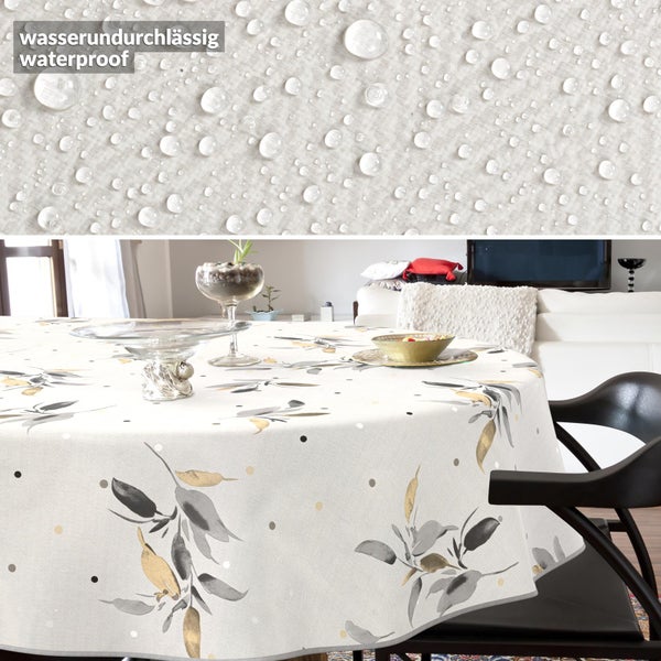 Runde wasserundurchlässige Tischdecke mit grau-goldenem Blattmuster auf einem Esstisch.