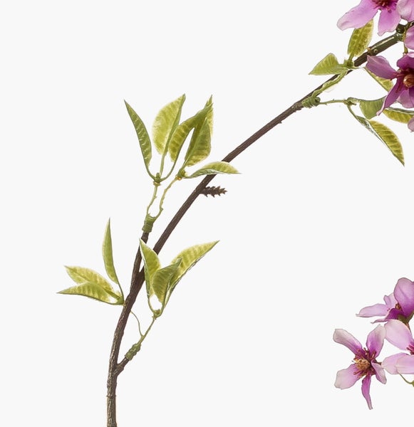 Künstlicher Blütenzweig mit rosa Blüten und grünen Blättern
