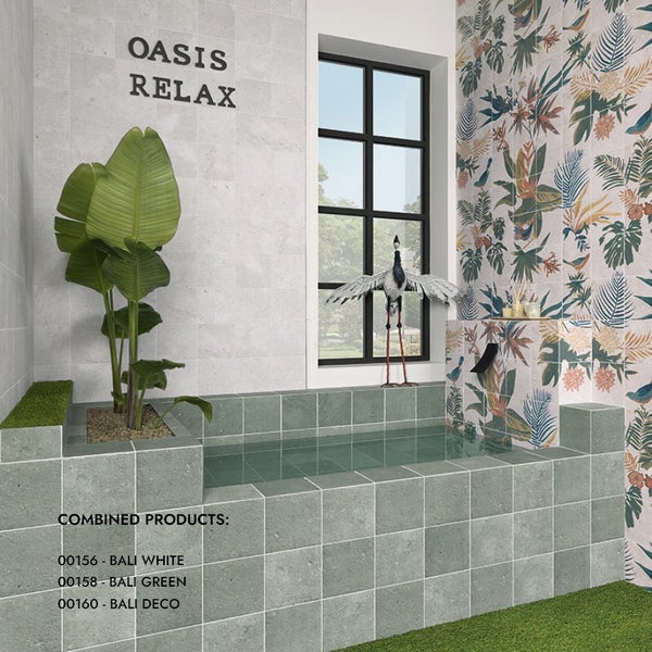 Badezimmer mit Bali Fliesen in Weiß und Grün sowie Dekorfliesen mit Pflanzenmotiven an den Wänden und der Badewannenverkleidung in Oasen Optik.